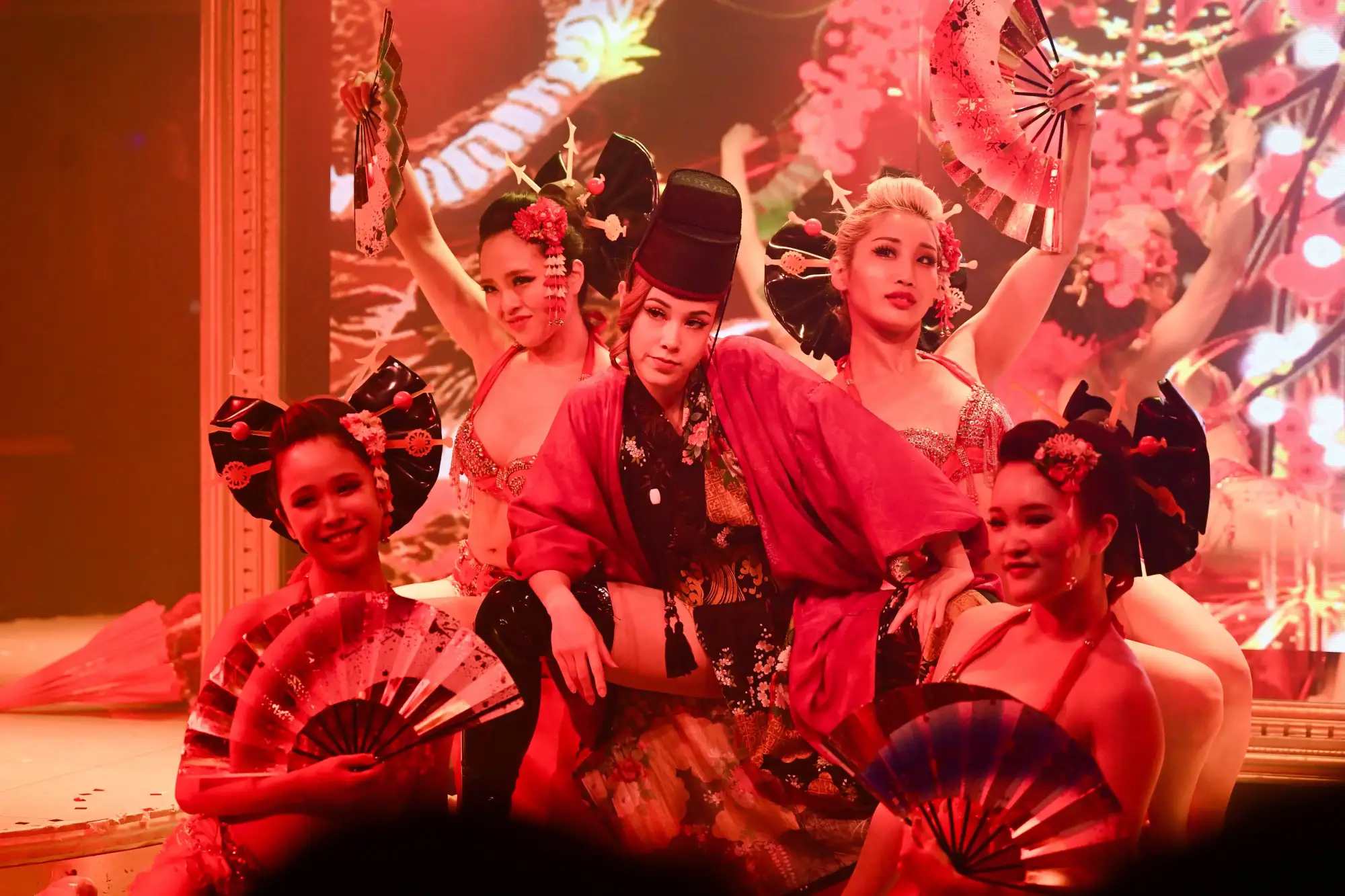 The full Tantra stage cast in red stage light