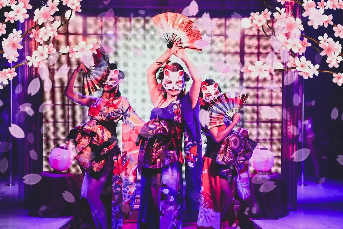 Cherry-blossom fan dancers in fox masks at Tantra